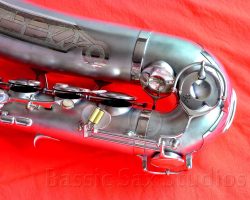 Olds Super tenor #108x silver saxophone against red background, Olds Super tenor sax, vintage American saxophone, rare saxophone, collectible saxophone,