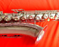 Olds Super tenor #108x silver saxophone against red background, Olds Super tenor sax, vintage American saxophone, rare saxophone, collectible saxophone,