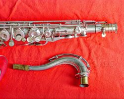 Olds Super tenor #108x silver saxophone against red background, Olds Super tenor sax, vintage American saxophone, rare saxophone, collectible saxophone,