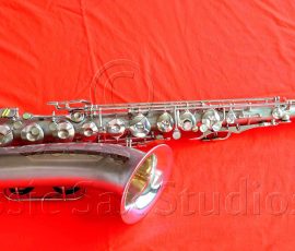 Olds Super tenor #108x silver saxophone against red background, Olds Super tenor sax, vintage American saxophone, rare saxophone, collectible saxophone,