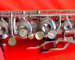 Olds Super tenor #108x silver saxophone against red background, Olds Super tenor sax, vintage American saxophone, rare saxophone, collectible saxophone,