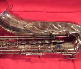 Original Hopf classic # 754x D&J copy of The New King. Source: A Friend of Bassic Sax vintage German tenor saxophone, Dörfler & Jörka, Original Hopf Classic, stencil sax, metal angel wing key guard, lower stack keys, silver plated sax on red background,