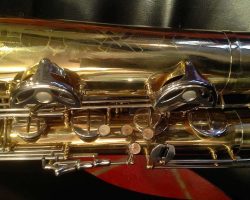 Rene Dumont low Bb bari # 15xxx. Source: Family Movie Warehouse on eBay.com vintage German saxophone, Dörfler & Jörka low Bb baritone sax, stencil sax, Rene Dumont, right hand keys, bell key guards with MOP buttons, two-tone horn