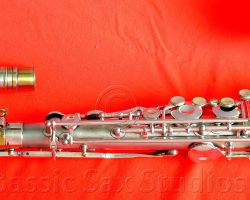 Olds Super tenor #108x silver saxophone against red background, Olds Super tenor sax, vintage American saxophone, rare saxophone, collectible saxophone,