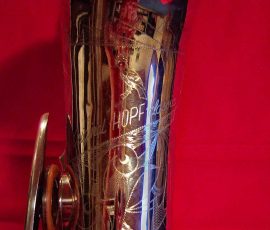 Original Hopf classic # 754x D&J copy of The New King. Source: A Friend of Bassic Sax vintage German saxophone, Dörfler & Jörka, Original Hopf Classic, stencil sax, bell engraving, silver plated horn on red background, D&J copy of Keilwerth The New King
