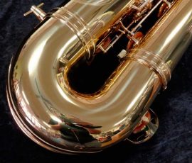 Source: saxquest.com bass saxophone, P. Mauriat, PM-350, gold lacquer bass sax, short wrap bass saxophone, French wrap, bow left side