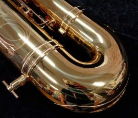 Source: saxquest.com bass saxophone, P. Mauriat, PM-350, gold lacquer bass sax, short wrap bass saxophone, French wrap, bow left side