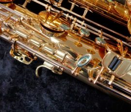 Source: saxquest.com bass saxophone, P. Mauriat, PM-350, gold lacquer bass sax, short wrap bass saxophone, French wrap, tone holes, key work