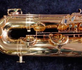 Source: saxquest.com bass saxophone, P. Mauriat, PM-350, gold lacquer bass sax, short wrap bass saxophone, French wrap