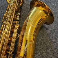 Serial # unknown. Source: rusbra_0 on eBay.com low A bari sax, Dave Guardala Artist Series baritone saxophone, floral engraving, lacquer saxophone