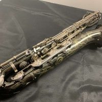 Serial # 013266. Source: Cliff's Gear Outlet on reverb.com low A bari sax, Dave Guardala Artist Series baritone saxophone, floral engraving, black nickel plated with silver plated keys, B&S