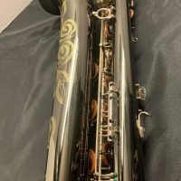 Serial # 013266. Source: Cliff's Gear Outlet on reverb.com low A bari sax, Dave Guardala Artist Series baritone saxophone, floral engraving, black nickel plated with silver plated keys, B&S