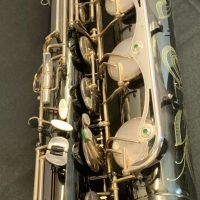 Serial # 013266. Source: Cliff's Gear Outlet on reverb.com low A bari sax, Dave Guardala Artist Series baritone saxophone, floral engraving, black nickel plated with silver plated keys, B&S