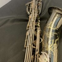 Serial # 013266. Source: Cliff's Gear Outlet on reverb.com low A bari sax, Dave Guardala Artist Series baritone saxophone, floral engraving, black nickel plated with silver plated keys, B&S