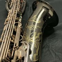 Serial # 013266. Source: Cliff's Gear Outlet on reverb.com low A bari sax, Dave Guardala Artist Series baritone saxophone, floral engraving, black nickel plated with silver plated keys, B&S