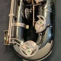 Serial # 013266. Source: Cliff's Gear Outlet on reverb.com low A bari sax, Dave Guardala Artist Series baritone saxophone, floral engraving, black nickel plated with silver plated keys, B&S