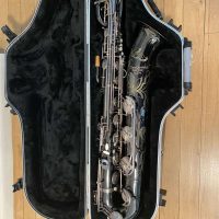 Serial # 013266. Source: Cliff's Gear Outlet on reverb.com low A bari sax, Dave Guardala Artist Series baritone saxophone, floral engraving, black nickel plated with silver plated keys, B&S