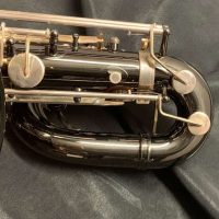 Serial # 013266. Source: Cliff's Gear Outlet on reverb.com low A bari sax, Dave Guardala Artist Series baritone saxophone, floral engraving, black nickel plated with silver plated keys, B&S
