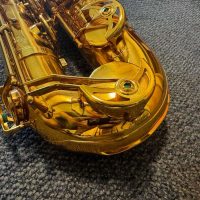 Serial # unknown. Source: rusbra_0 on eBay.com low A bari sax, Dave Guardala Artist Series baritone saxophone, floral engraving, lacquer saxophone