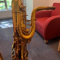 Serial # unknown. Source: rusbra_0 on eBay.com low A bari sax, Dave Guardala Artist Series baritone saxophone, floral engraving, lacquer saxophone