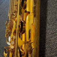Serial # unknown. Source: rusbra_0 on eBay.com low A bari sax, Dave Guardala Artist Series baritone saxophone, floral engraving, lacquer saxophone