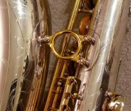 Source: adbforyour on eBay.com DG-502 tenor sax, New York Series, series features NY skyline features engraved all over the keywork & bell, rich engraving all over the instrument, Dave Guardala tenor saxophone, silver plate with gold plated keys,