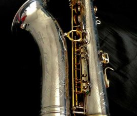Source: adbforyour on eBay.com DG-502 tenor sax, New York Series, series features NY skyline features engraved all over the keywork & bell, rich engraving all over the instrument, Dave Guardala tenor saxophone, silver plate with gold plated keys,