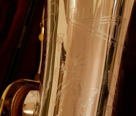 Source: adbforyour on eBay.com DG-502 tenor sax, New York Series, series features NY skyline features engraved all over the keywork & bell, rich engraving all over the instrument, Dave Guardala tenor saxophone, silver plate with gold plated keys,