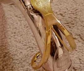 Source: adbforyour on eBay.com DG-502 tenor sax, New York Series, series features NY skyline features engraved all over the keywork & bell, rich engraving all over the instrument, Dave Guardala tenor saxophone, silver plate with gold plated keys,